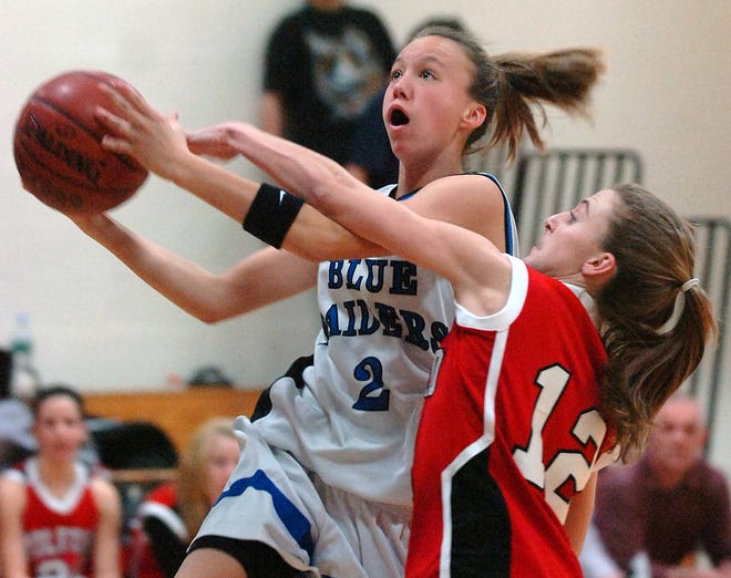Hopedale scoring star Lekia Cowen gets fouled going to the hoop by Milford's Kaitlyn Barth.