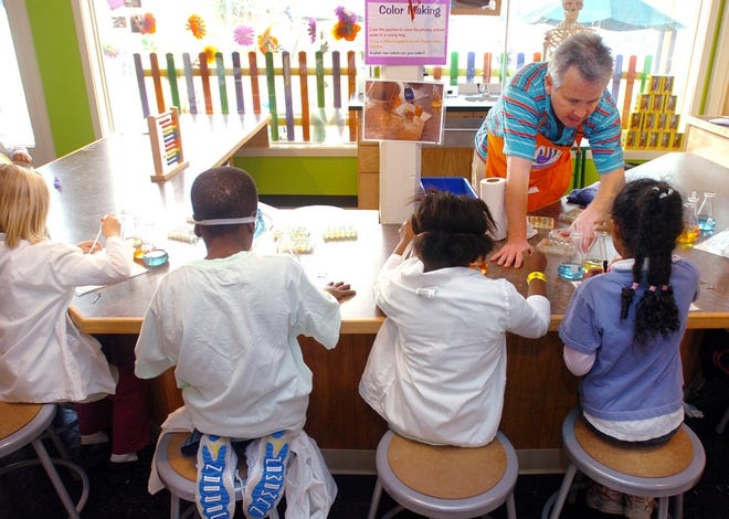 Play Specialist Eddie Hudson instructs children on science experiments at the Children's Museum on Dec. 14.