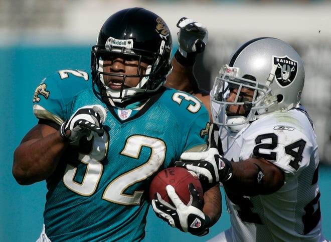 Jacksonville Jaguars running back Maurice Jones-Drew, left, runs for second-quarter yardage as the Oakland Raiders' Michael Huff attempts to make the tackle Sunday.