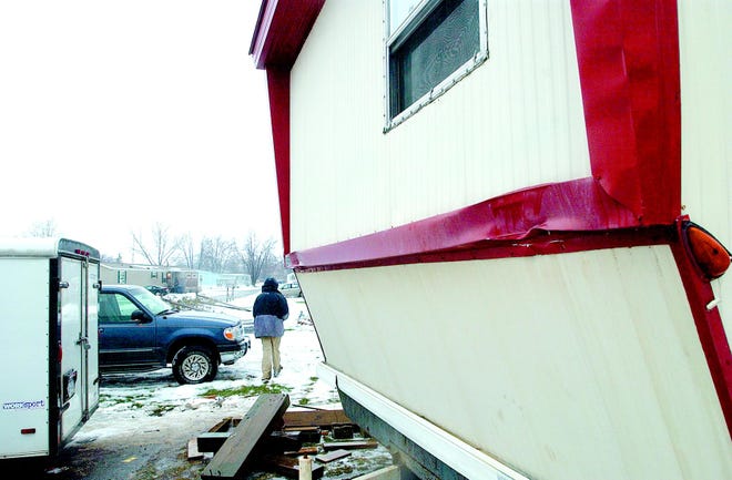 Kathy Potter’s trailer was moved from Red Jacket Trailer Park on Nov. 30. It took 10 days to get her electricity turned on. She is still waiting for sewer and water. And the movers broke her kitchen window. More damage to the trailer is seen at the front corners. Potter says it was fine before the move now the corners are dented. Her son Jarrid Potter is seen walking on the property.