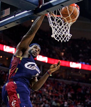 LeBron James dunks part of his game-high 25 during Cleveland's win over Miami on Tuesday.