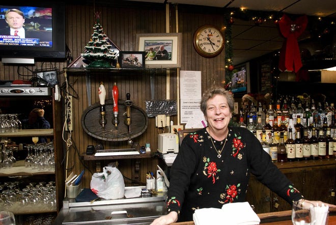 Jamie’s Pub owner Linda Scott-Constantine tends bar on Monday night, during the pub’s annual Christmas Eve buffet.