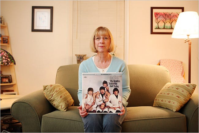 Janice Moore with a replica of a rare Beatles album that brought her $8,000.