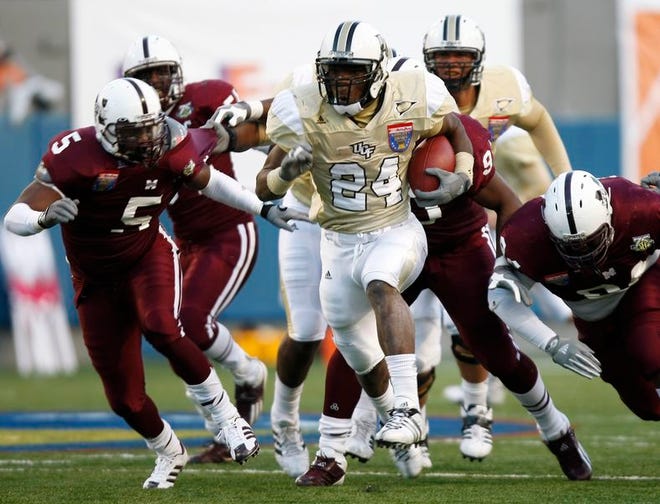 Central Florida running back Kevin Smith (24) gets away from Mississippi State linebacker Gabe O'Neal (5) and defensive lineman Rodney Prince, right, in the second quarter of the Liberty Bowl on Saturday in Memphis, Tenn.