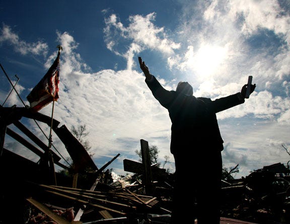 The Rev. Larry Lynn leads the service at the site of the Lady Lake Church of God in Lady Lake on Sunday, Feb. 4. During any kind of storm coverage, photographing people who have lost everything can affect anyone. This morning, however, was different. People gathered together to pray and comfort each other, and although there were lots of tears, there were also a lot of smiles and people singing and holding hands. Instead of sadness and despair, there was an overwhelming feeling of hope. That feeling was what I wanted to capture.