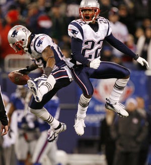 New England Patriots cornerback Ellis Hobbs III (left) and Asante Samuel celebrate after Hobbs' intercepted a pass from New York Giants quarterback Eli Manning during the fourth quarter at Giants Stadium in East Rutherford, N.J., Dec. 29.
