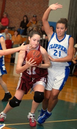 Killingly's Paulette Wyatt, left, moves toward the basket with the ball as Putnam's Katelyn Tarr, right, defends during the Clipper Classic basketball tournament at Putnam High School on Saturday, December 29, 2007.