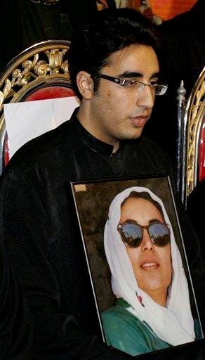 Bilawal Zardari, son of Pakistan's slain former prime minister Benazir Bhutto, holds a picture of his mother as he addresses a news conference in Naudero, near Larkana, Pakistan on Sunday, Dec. 30, 2007. Bilawal has been appointed Chairman of Bhutto's Pakistan People's party. (AP Photo/Shakil Adil)
