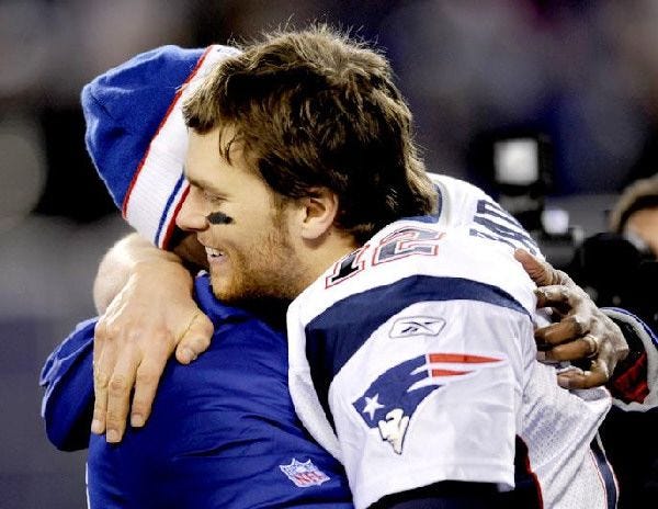 Tom Brady showed his emotions after Saturday’s win and earned a hug after the Patriots finished off a 16-0 regular season.