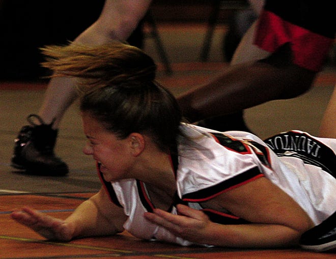 Taunton's Katie O'Connor falls to the ground during the Tigers' game with Brockton Friday night. Taunton lost 62-33.