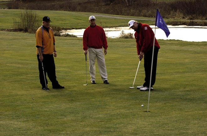 From left, Chris Harrington, of Bridgewater, Mike Lynch and Peter Hamill, both of Norton, play a little golf on the thirteenth hole at Segregansett Country Club in Dighton. Sunday afternoon's relativly warm temperatures were a welcome relief from the frigid cold at the beginning of the week.