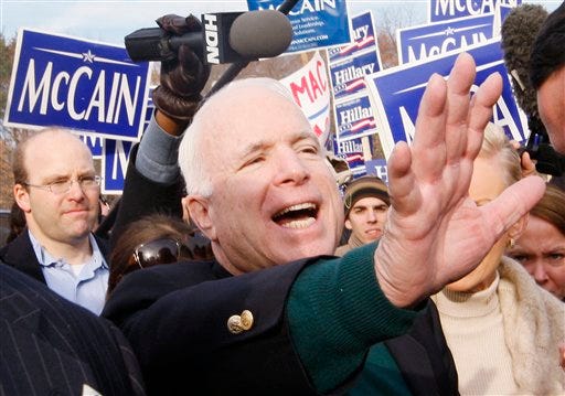 Republican Presidential hopeful, Sen. John McCain, R-Ariz., waves to supporters during a stop by a polling station at the Broad Street Elementary school the morning of New Hampshire's Presidential Primary election, Tuesday, Jan. 8, 2008, in Nashua, N.H. (AP Photo/Charles Dharapak)