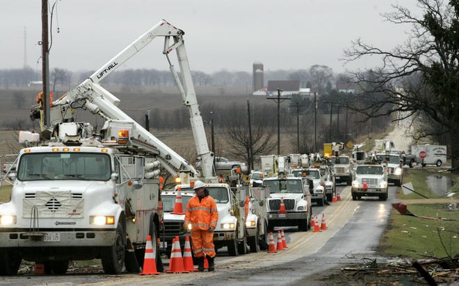 ComEd trucks line Centerville Road in Poplar Grove on Jan. 8. Employees were working to restore power.