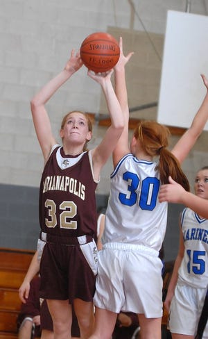 Marianpolis's Shannon Cain, left, shoots a basket past Falmouth defender Anna Van Voorhis, right, at Marianapolis Preparatory School in Thompson on Saturday, January 12, 2008.