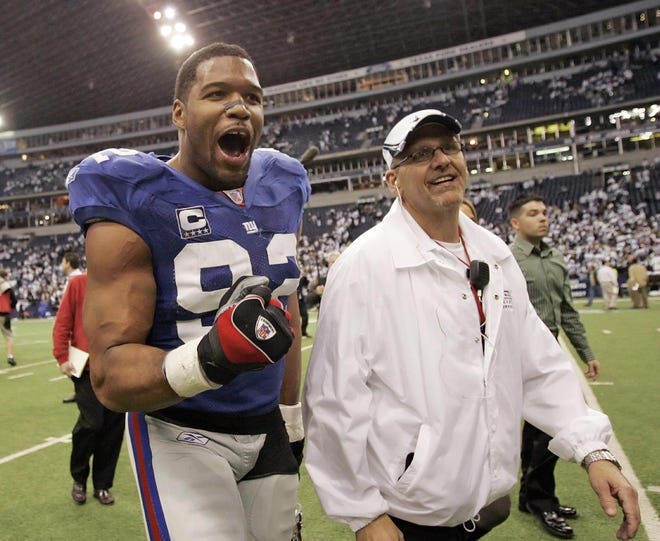 New York Giants defensive end Michael Strahan lets out a yell as he leaves the field after the Giants' 21-17 win over the Dallas Cowboys on Sunday, Jan. 13, 2008, in Irving, Texas. The win allows the Green Bay Packers to host the NFC Championship game Sunday, Jan. 20.