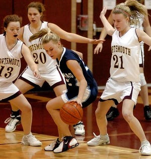 STA's Shannon Kean plays the ball as she's surrounded by Portsmouthís Stef Biron (13), Onni Irish (20) and Callie Bacon (21) during the first quarter of Wednesday night's Class I game in Portsmouth.