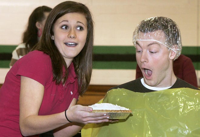 Student council vice president Stefanie Hamaker and 8th-grade English teacher Kevin Finnegan ham it up for the students at North Boone Middle School on Jan. 16, 2008, during a Pie War fundraiser.