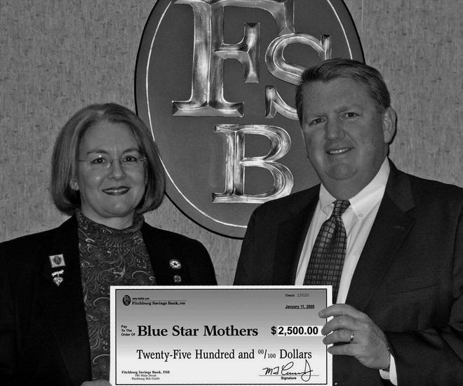 Sharon Bouchard, the president of the Massachusetts chapter of the Blue Star Mothers, accepts a check for $2,500 from Martin Connors, president and CEO of Fitchburg Savings Bank. The Blue Star Mothers is comprised of moms who have or have had children serving in the military, and the organization provides supplies to soldiers both here and abroad. The money was raised through donations for calendars and money envelopes. SUBMITTED PHOTO
