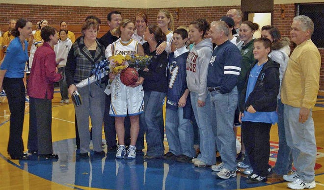 Lindsay DelleChiaie, daughter of Steve and Megan DelleChiaie of Leominster, and captain of the Worcester State College women's basketball team, scored her 1,000th point during a tournament in Oregon on Dec. 29. A celebration was held in her honor, with family, friends, teammates and coaches, at a home game last week at Worcester State. Lindsay, a senior at Worcester State, had also scored 1,000 points during her Leominster High School career. SUBMITTED PHOTO