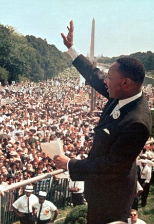 Martin Luther King Jr. acknowledges the crowd at the Lincoln Memorial for his “I Have a Dream” speech on Aug. 28, 1963, during the March on Washington D.C. He was assassinated April 4, 1968, in Memphis, Tenn. The Washington Monument is in the background.