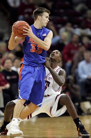 Florida's Nick Calathes, left, tries to get past the defense of South Carolina's Dwayne Day in the first half of their game in Columbia, S.C., on Wednesday.