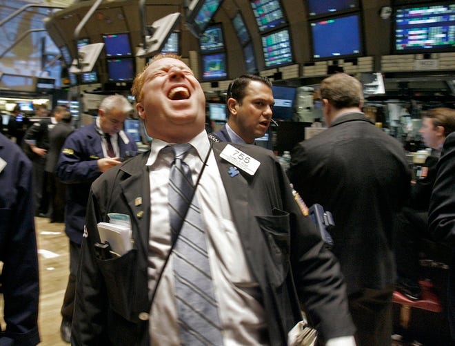 Trader Daniel Ryan laughs as he works on the floor of the New York Stock Exchange on Wednesday.