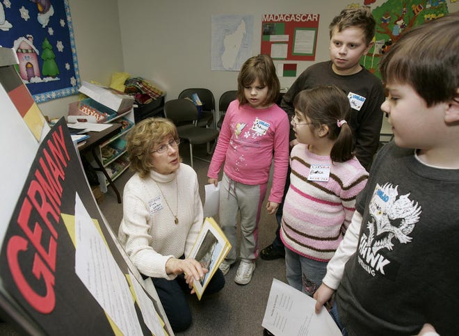 Fran Larson talks about Germany with participants (from left) Rebecca Theisen, 6; Nate Theisen, 9; Bianca Aguirre, 7; and Lynden Hill, 8, during an Around the World in 90 Minutes program Jan. 26, 2008, at the Northeast Branch of the Rockford Public Library.