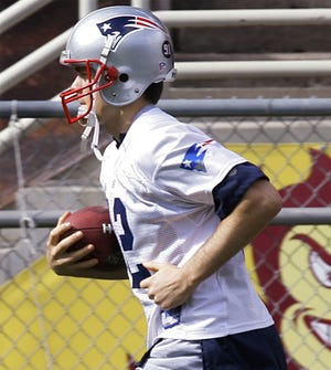 Tom Brady, whose injured right ankle was taped, runs during practice.