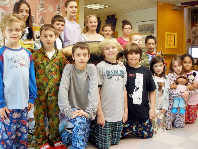 Students at Wallenpaupack South Elementary School donned pajamas on January 18 to raise money for a friend in need. From left, kneeling are: sixth-graders, Anthony Guerrieri, Thomas McLain and Tyler Ferber; second-graders, Courtney Mooney, Cossette Peirone and Nellymar Camacho. Middle row: second-graders, Noah Price, Kyle Landolfi, first-graders, Joe Smith and Timothy Holzapfel. Back row: sixth-graders, Sadie Frunzi, Devin Knowles, Natalie Christopher, Nicki Mann, Nadia Neary and Kristina Roy.
