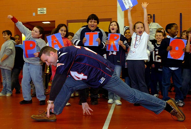 McCarthy School fourth grade teacher Matt Hanlon does a dance after fourth graders spelled the word "Patriots" during the school's Patriots Pep Rally Friday afternoon.