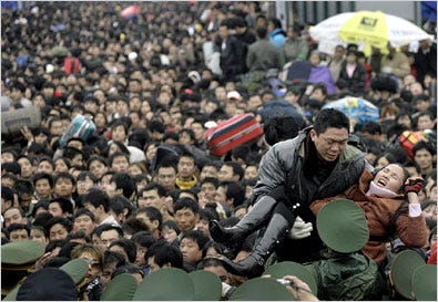 A sick passenger was carried from the crowd of travelers on Thursday at the train station at Guangzhou, China.