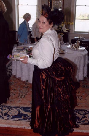 Joan Levy serves guests at the Victorian Tea.