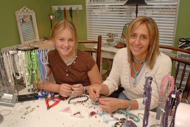 Jewelry designer Justine Vanderlugt and her daughter Grace make jewelry together in her home work shop. (John Carrington/Savannah Morning News)