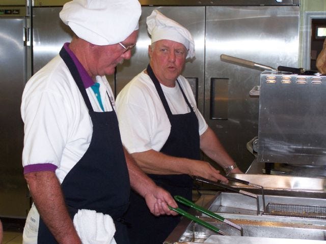 Post Commander Jack Goin (left) and Quartermaster Bill McCormick prepare fish and the french fries during a recent Fish Fry dinner.