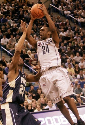 Connecticut's Craig Austrie comes in for a shot over Pittsburgh's Sam Young in a college basketball game in Hartford, Conn., Saturday, Feb. 2, 2008. Connecticut won 60-53.