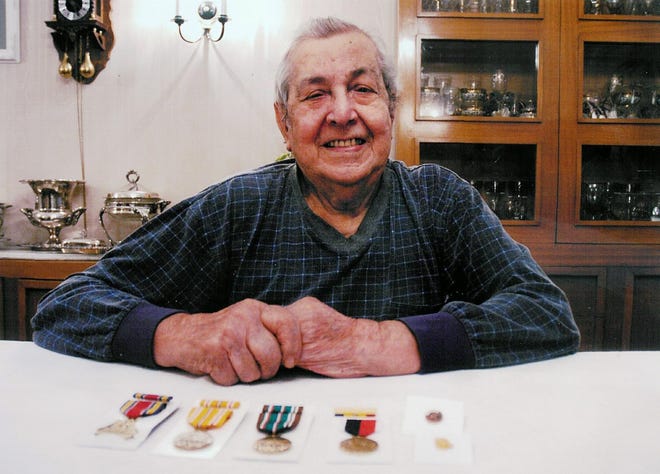 Moses LaBella, 84, of Utica, sits proudly behind his medals her earned in the Navy during World War II. It took more than 60 years for LaBella to receive his medals.