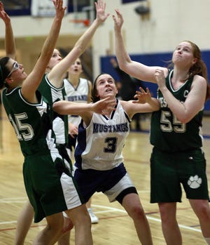 Medway's Katy Howard fights off two Westwood players for a rebound.