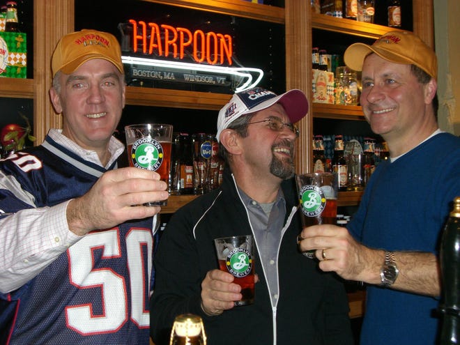 Harpoon co-founders Dan Kenary, left, and Rich Doyle, right, toast to Brooklyn Brewery owner Steve Hindy at the Harpoon Brewery in Boston.