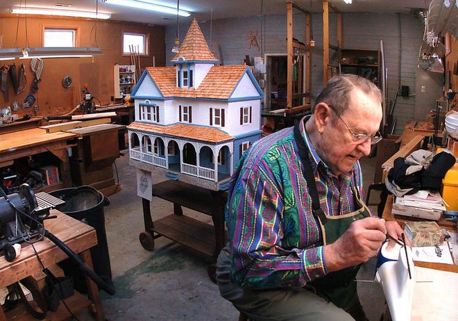 Bob Bach works on his radio-controlled model airplane in the Plantation Village woodworking shop.