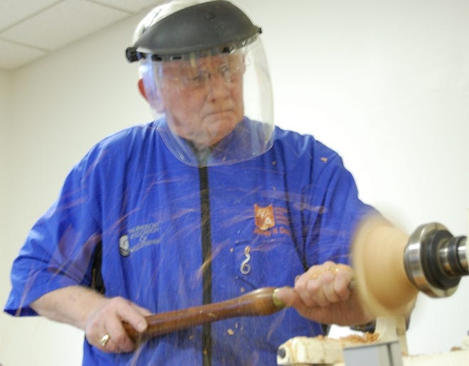 Jeffrey Davies demonstrates for the Wilmington Area Woodturners Association how to turn out a natural edged bowl from a piece of green wood.