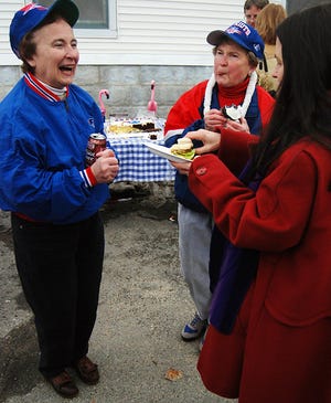 Sisters Beverly Lamburn, left, and Barbara Holmer are decked out in Patriots gear as they chat with Donna Horvath at a "Souper Bowl" celebration hosted by the First Baptist Church to raise money for Loaves and Fishes Sunday.