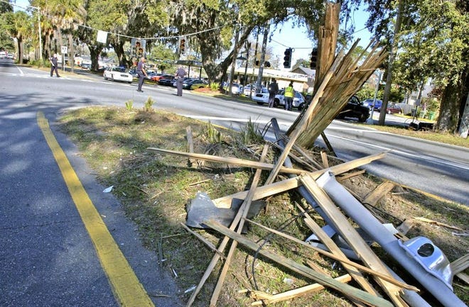 A single-vehicle accident Thursday morning left a utility pole smashed and stoplights dangling at Victory Drive and Whatley Avenue. (Carl Elmore/Savannah Morning News)