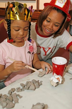 Youth programs for learning crafts were among the programs at the Savannah Black Heritage Festival. Jaleah Carswell, left, enjoys making clay art and Sherelle Jones watches her on the grand festival day, Saturday. (Ayano Hisa/Savannah Morning News)