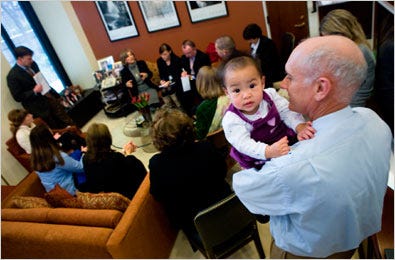 Russ Giesy holding his granddaughter, Jordan McRoberts, during a recent three-family meeting with Senator Barbara Boxer.