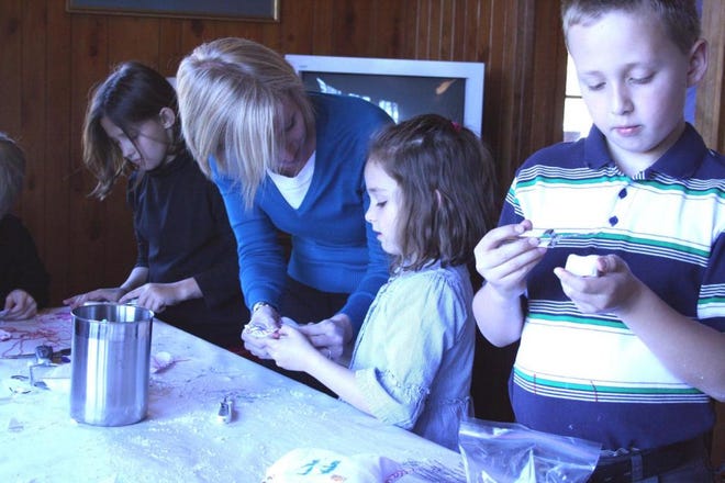 Richmond Hill CVB Director Christy Hyer helps Jennifer Yoder stitch together a doll while Katherine and Lucas Yoder work on soap carvings at the Richmond Hill Museum, during Super Museum Sunday. (Jamie Parker/Bryan County Now)