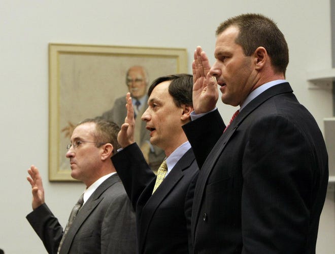 Roger Clemens (right) is sworn in on Capitol Hill.