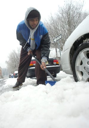 William Francois of Strodsuburg digs out his wife's car at their house in Strodusburg on Wednesday afternoon, Feb. 13, 2008.
