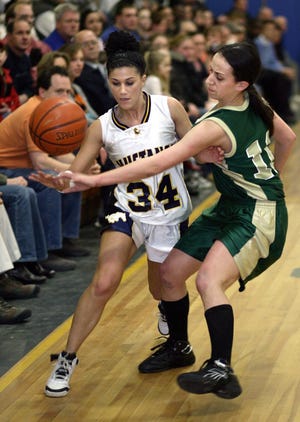 Marian guard Jess Morin gets the ball slapped away by Matignon's Alyssa Murphy (left) during their Catholic Central Small contest.
