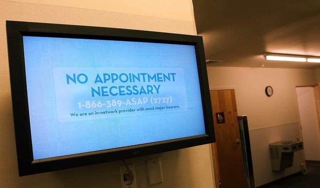 A sign welcomes patients to the MinuteClinic inside the CVS pharmacy in Coventry, Conn.