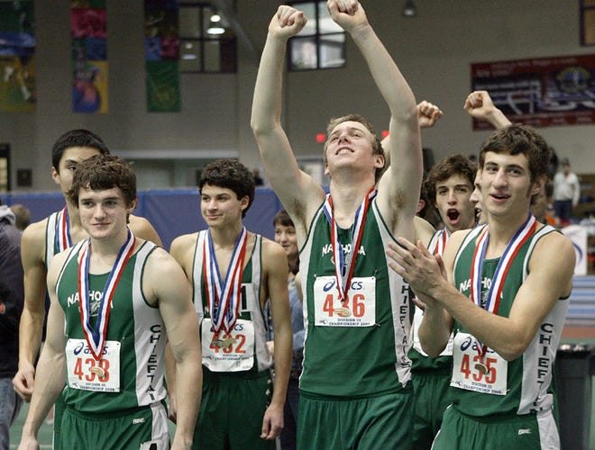 Members of the Nashoba boys indoor track team celebrate after winning the Div. 3 state championship.